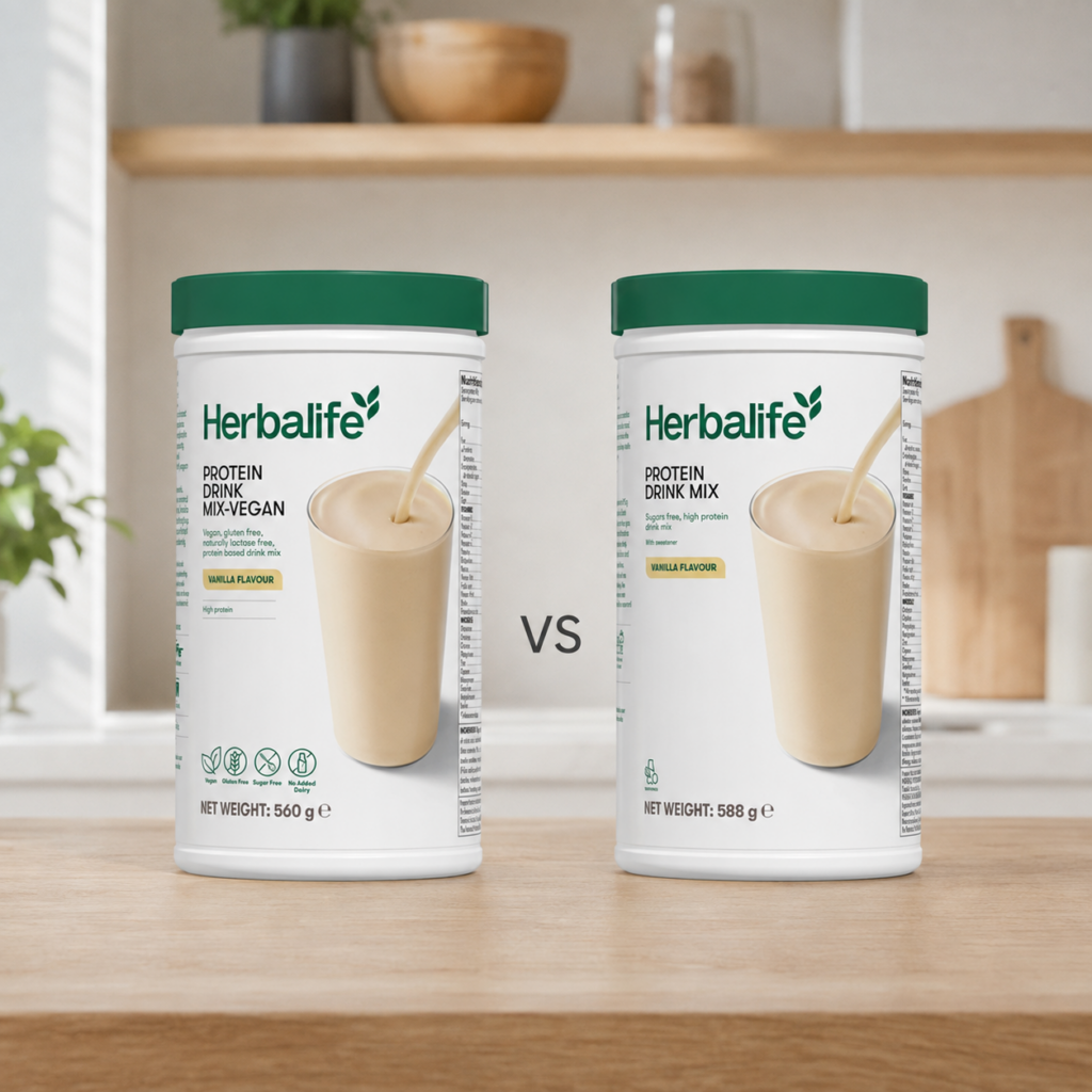 Herbalife Protein Drink Mix Vegan Vanilla 560 g and Herbalife Protein Drink Mix Vanilla 588 g displayed side by side with a VS comparison on a kitchen table.