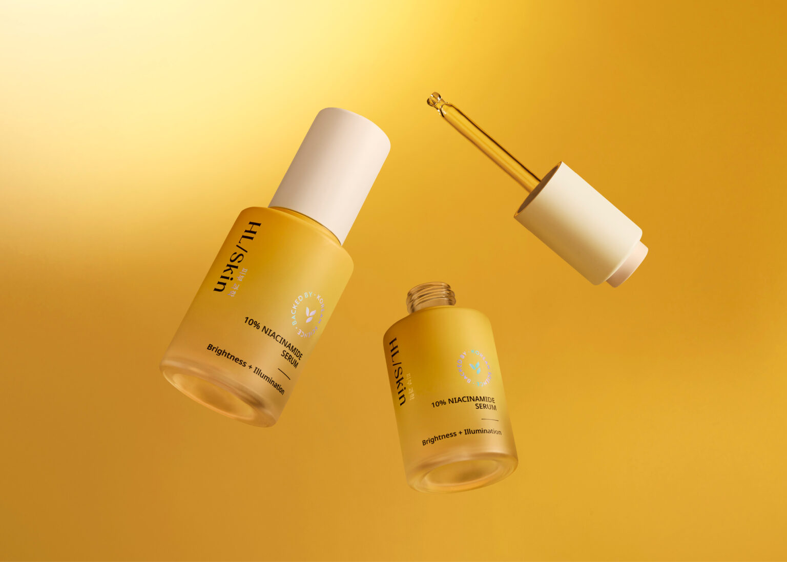 HL/Skin 10% Niacinamide Serum bottles with dropper on a gold background