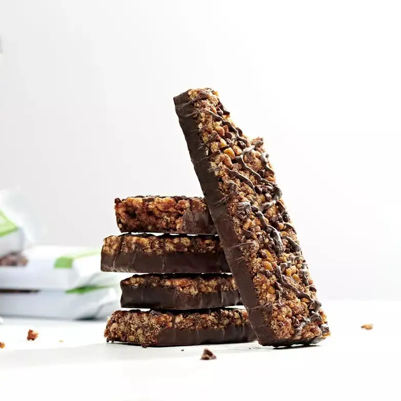 A stacked pile of Herbalife Formula 1 Express healthy meal bars with dark chocolate drizzle on a clean white background.